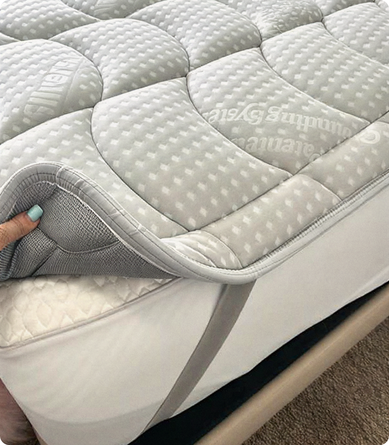 Close-up of the Grounding Topper being lifted off a mattress corner